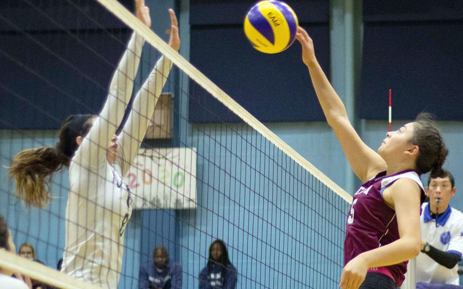 Seisen's Lilu Vandercamme tries to hit past Kubasaki's Abby Robinson.