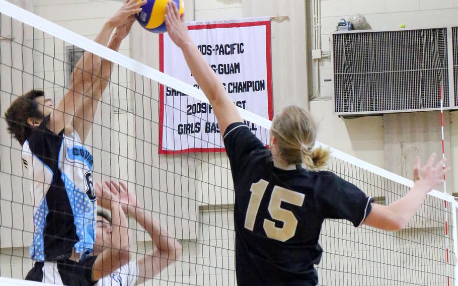 Humphreys' Kieran Blessing and Osan's MinSung Kim go up at the net for the ball during the Blackhawks' four-set win over the Cougars.