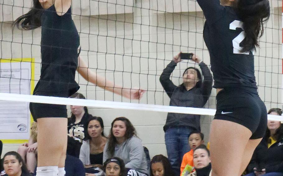 Humphreys' Ariel Stickar and Osan's Maja Inthavixay battle at the net for the ball during the Cougars' three-set win Saturday over the Blackhawks.