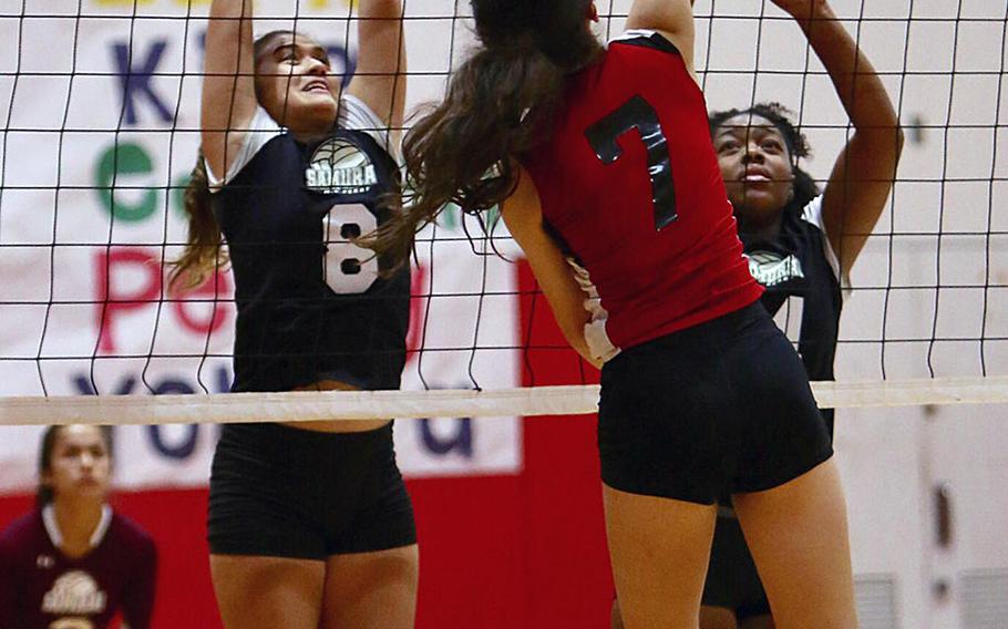 E.J. King's Miya O'Mara goes up to hit against Matthew C. Perry's Hazel Bolduc and Taniya Smith during Thursday's match in the DODEA Japan girls volleyball tournament. The Cobras won in four sets.