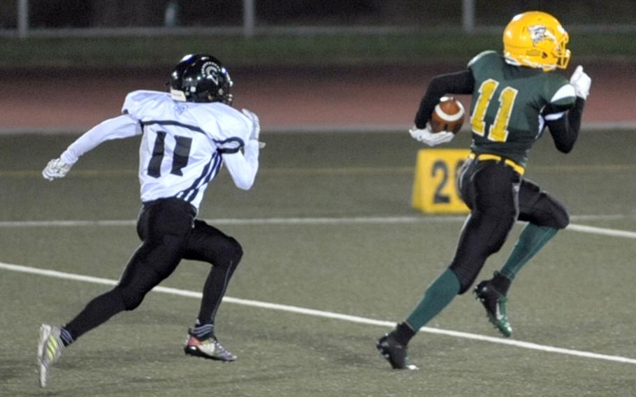 Eagles receiver A.J. Nelson outruns Trojans defender Justyn Seraphin to the end zone with one of his three touchdown catches.