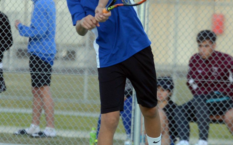 Yokota's Kai Deremer hits a backhand smash during his 8-4 win over Nile C. Kinnick's Daniel Posthumus during Friday's boys singles A play in the DODEA-Japan tennis tournament.