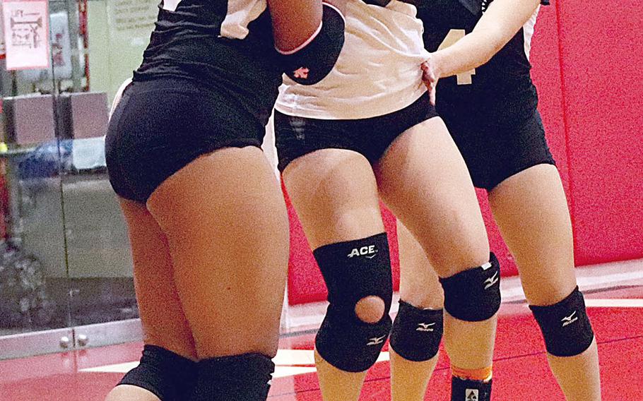 Zama's Grace Bryant, Aika Davis and Liann So celebrate following Saturday's DODEA-Japan girls volleyball tournament final. The Trojans rallied from one set down to beat host Nile C. Kinnick in four sets.