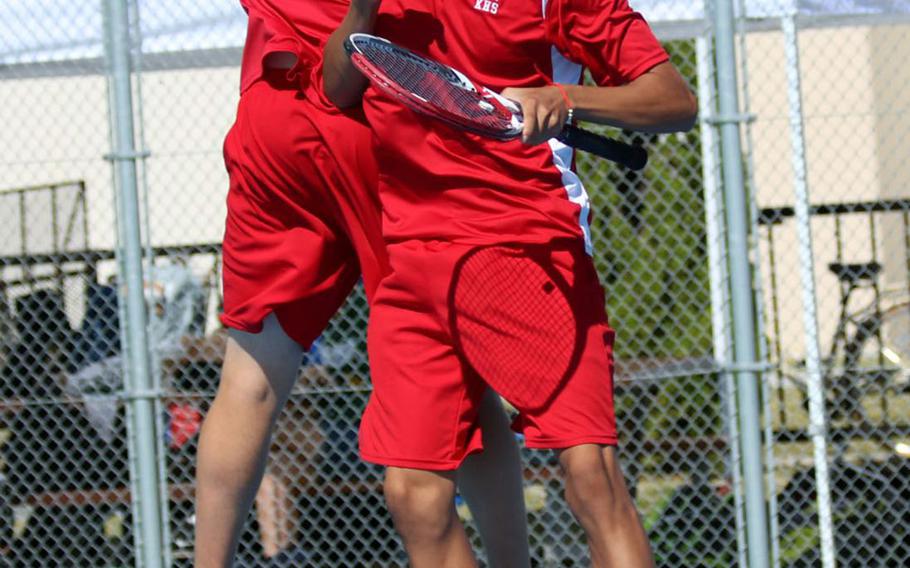 Nile C. Kinnick's Daniel Posthumus and Matthew Manson celebrate following a point during during Saturday's boys doubles final in the DODEA-Japan tennis tournament. They lost to E.J. King's Takumi Kodama and Johnathon Lee for the title.