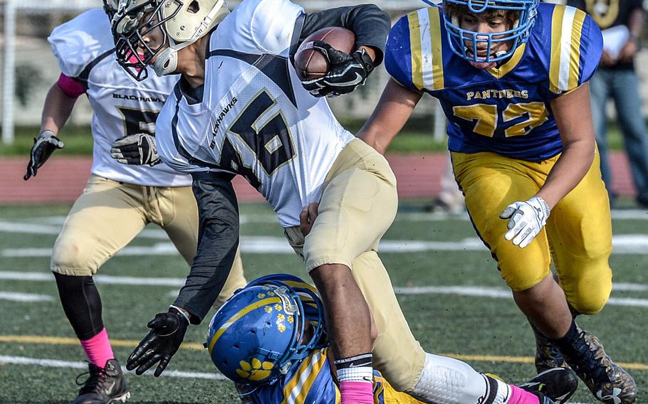 Humphreys' Brandon Hill tries to maintain his balance between two Yokota defenders.