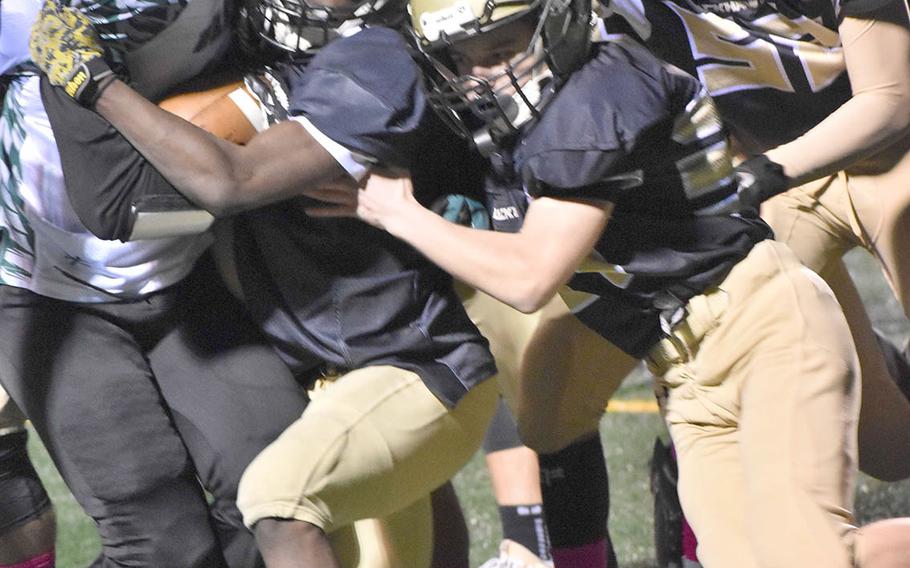 Daegu running back Sam Murphy gets gang-tackled by a slew of Humphreys defenders.