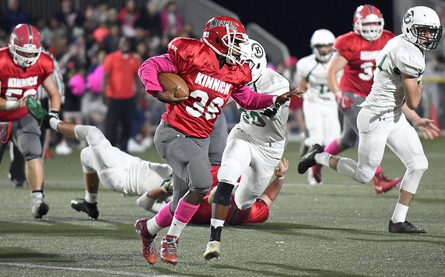 Kinnick running back Travion Morton looks to avert a tackle by Kubsaaki's Keonte Caines.