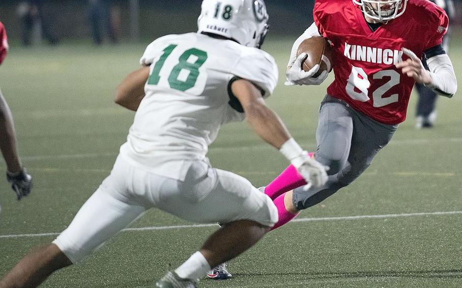 Kinnick receiver Haydn Guiste looks to avoid the tackle of Kubasaki's Jaylan Penney.