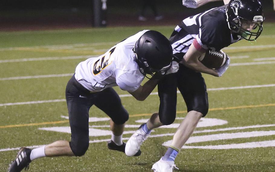 American School In Japan's Dean Hahne brings down Zama's Sean Sullivan.
