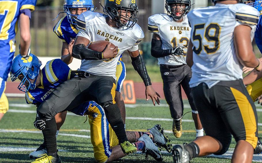 Kadena running back Warren Joseph looks for running room.