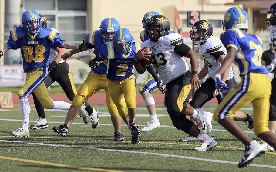 Kadena running back Uriah Morris charges downfield through the Yokota defense.