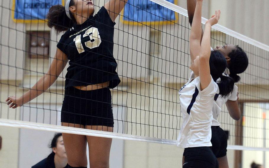 Humphreys' Ebony Dykes skies high over the net to play the ball against Seoul American.