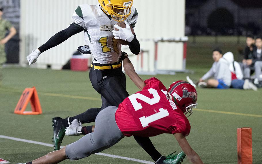 Edgren receiver A.J. Nelson tries to make for the corner of the end zone ahead of Kinnick defender Justice Jackson.