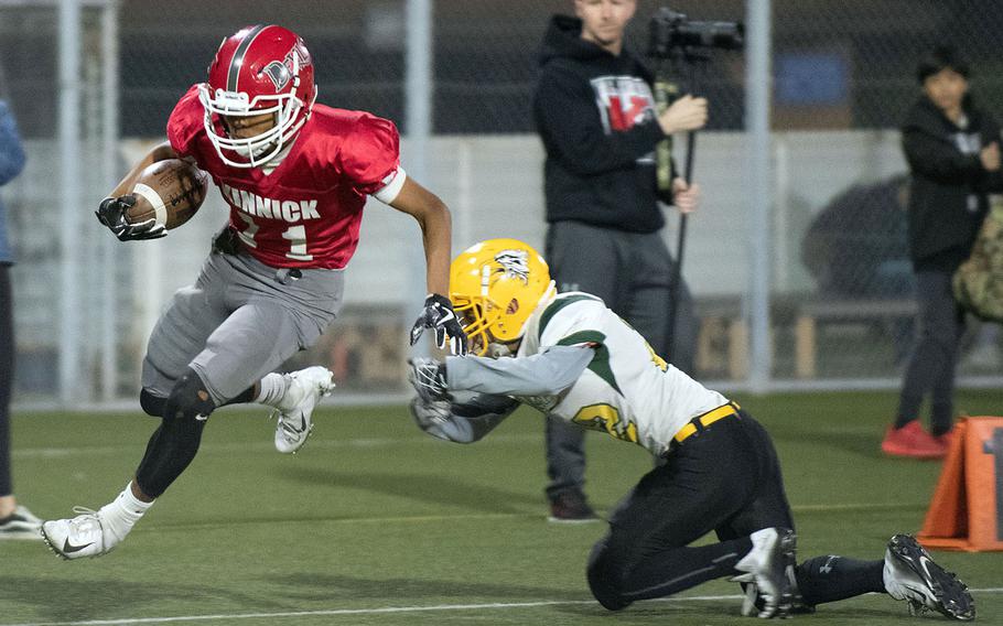 Kinnick receiver Kaine Roberts leaps away from Edgren would-be tackler Douglas Tackney.