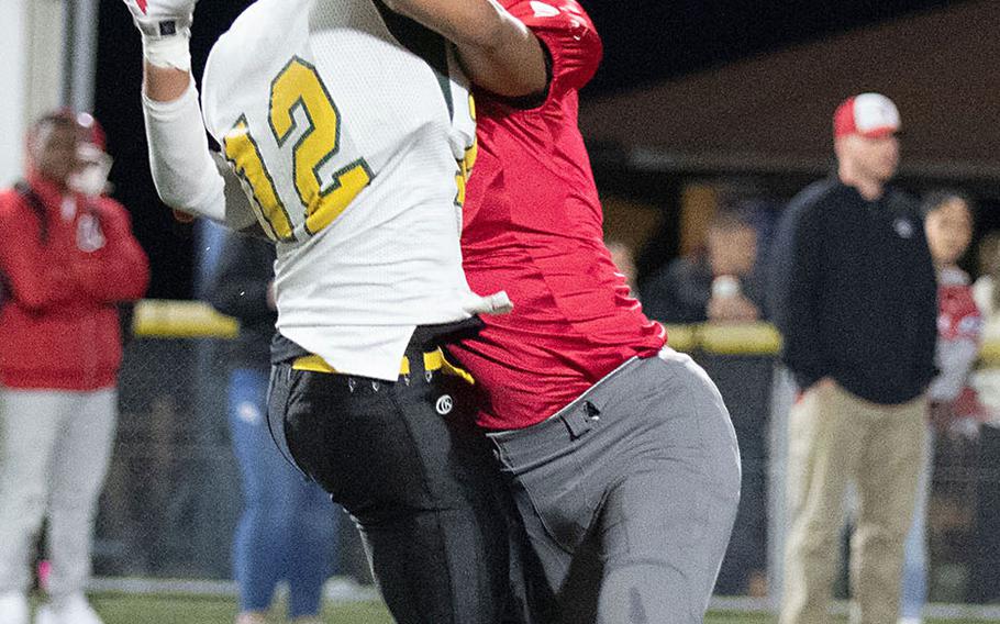 Edgren quarterback Raphael Lykins just gets the pass off in time as he gets belted by Kinnick defender Justice Jackson.