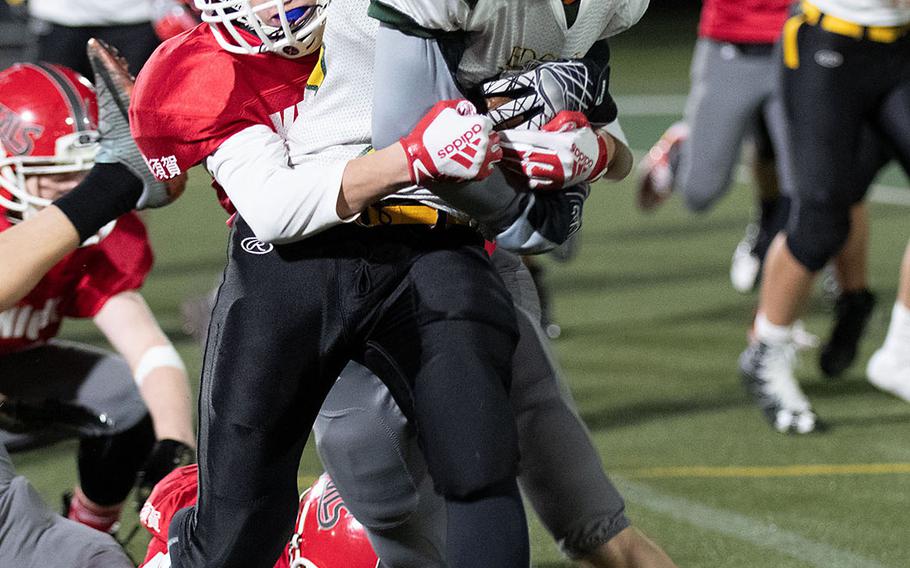 Edgren running back Ayden Jaquez gets bottled up by Kinnick defender Christian Maruyama.