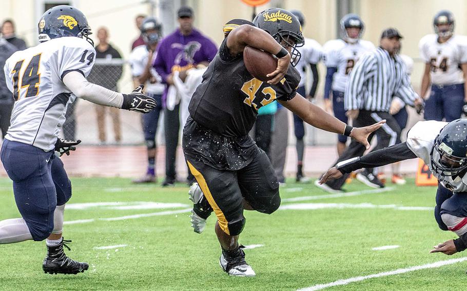 Kadena running back Uriah Morris knifes his way between two Guam High defenders. Morris led all players with 198 yards and two touchdowns on 25 carries.