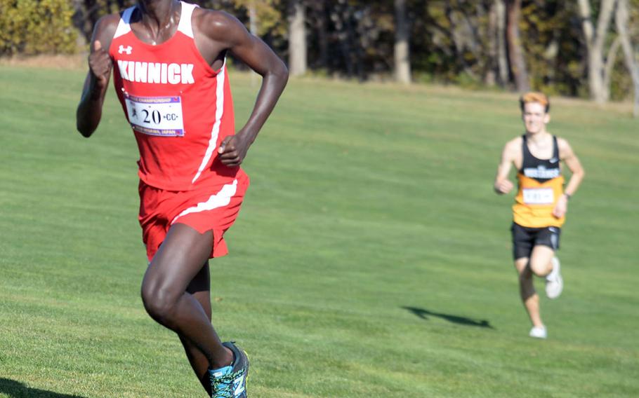 Nile C. Kinnick senior Akimanzi Siibo leads American School In Japan's Trevor McAuliffe down the stretch in the Division I boys race.