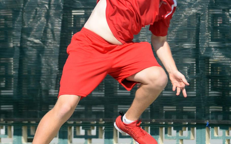 Kinnick's Daniel Posthumus launches a serve during Wednesday's boys singles play in the Far East tennis tournament. Posthumus beat Seoul American's Scotty Peterson and St. Mary's Andy Matsuzaki by identical 8-0 scores to reach the quarterfinals.