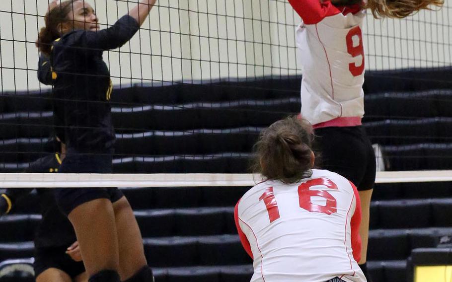 Kadena's Brie Barnett and Kinnick's Melissa Rose battle for the ball at the net during Friday's elimination match in the Far East Division I girls volleyball tournament. The Red Devils beat the Panthers in three sets.