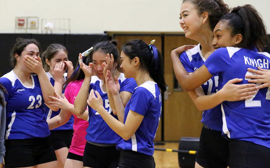 Christian Academy Japan Knights volleyball players celebrate their Far East Division II tournament title.