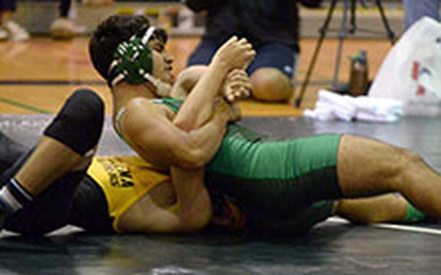Kubasaki's Ruban Saavedra gains the advantage over Kadena's Logan Howell in the 148-pound bout during Friday's Okinawa wrestling dual meet. Saavedra pinned Howell in 2:58 and the Dragons won the meet 44-17.