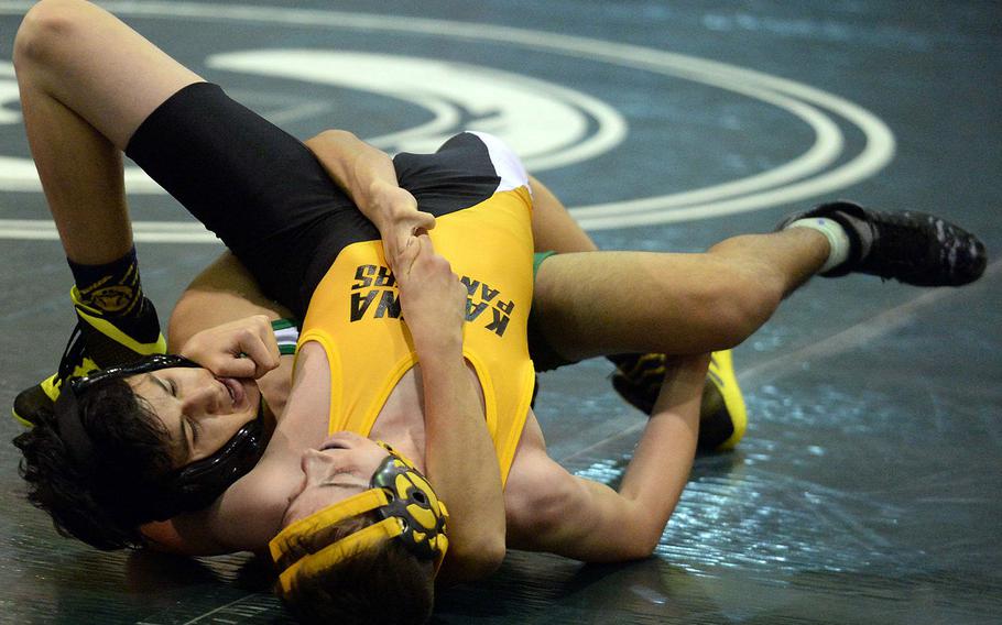 Kubasaki's Noah Vasquez and Kadena's Aiden Mason battle for the advantage in the 108-pound bout during Friday's Okinawa wrestling dual meet. Mason pinned Vasquez in 2:40, but the Dragons won the meet 44-17.