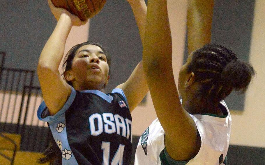 Osan's Maja Inthavixay shoots against Daegu's Dai'Ja Turner during Thursday's Korea girls basketball game. The Warriors won 39-25.