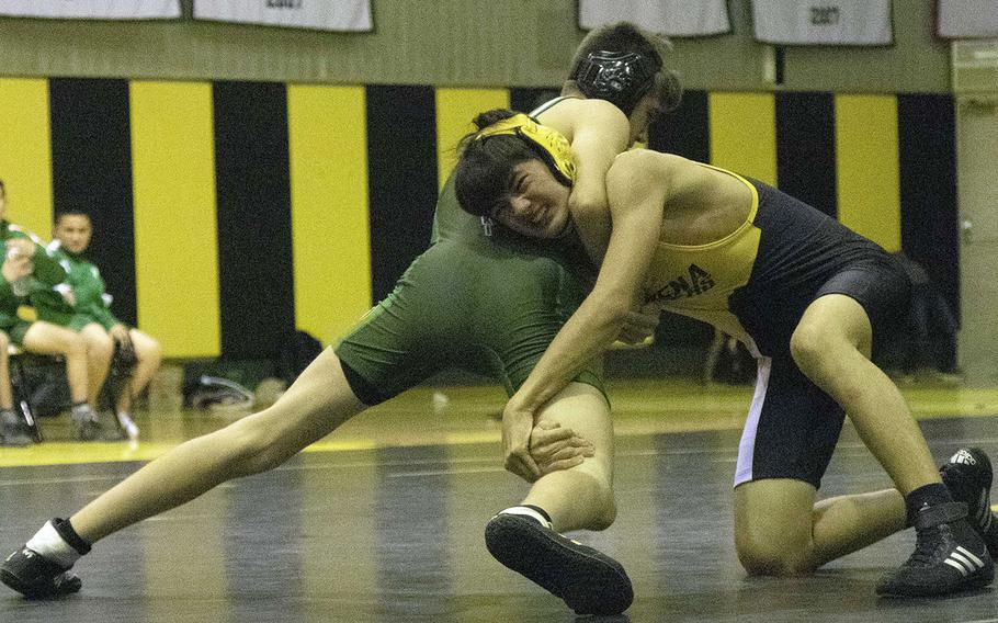 Kadena's Paul Maskery and Kubasaki's Adrian Misenhimer fight for control in the 135-pound bout during Wednesday's Okinawa wrestling dual meet. Misenhimer pinned Maskery in 3 minutes, 58 seconds, and the Dragons won the dual meet 35-26.