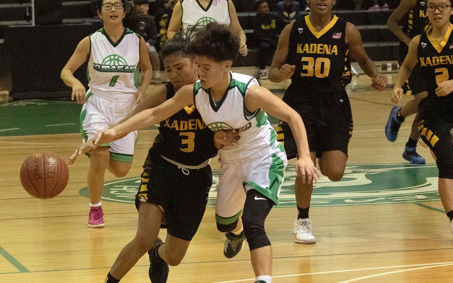Kubasaki's Ari Gieseck slaps the ball away from Kadena's Korina Macato during Friday's Okinawa girls basketball game, won by the Panthers 47-11.