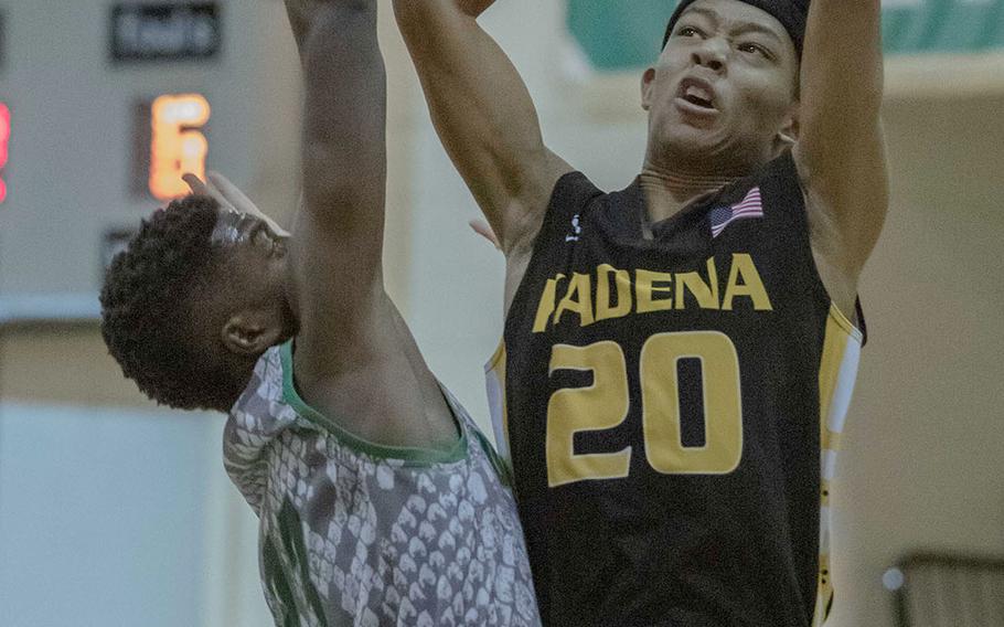 Kadena's Kai Harris shoots against Kubasaki's Damien Dorval during Friday's Okinawa boys basketball game, won by the Panthers 72-53. Harris' father, Marvin, played for the Panthers in the mid-1990s and won a Far East championship in 1995.