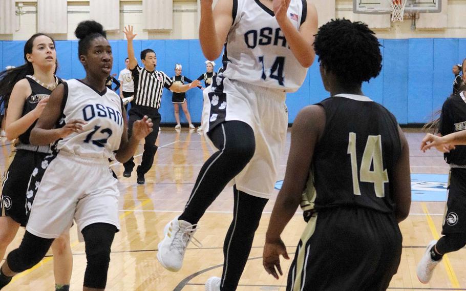 Osan's Maja Inthavixay goes up for a shot against Humphreys' Acacia May during Friday's Korea girls basketball game, won by the Blackhawks 47-36.