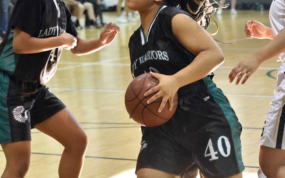 Daegu's Bethani Newbold drives past Humphreys' Maria Bruch to the basket during Saturday's Korea girls basketball game. The Warriors rallied for a 48-44 win over the Blackhawks.