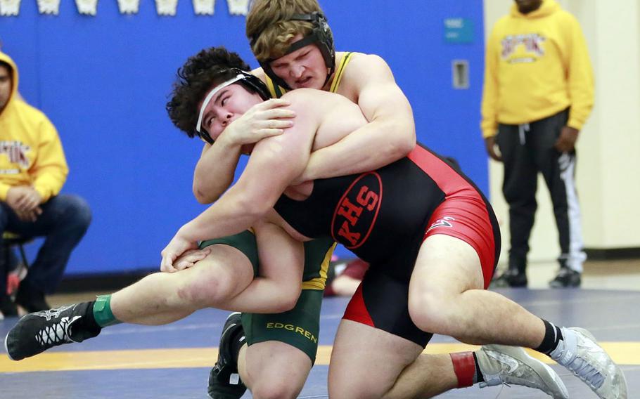 Nile C. Kinnick's Chris Mason and Robert D. Edgren's Chase Quigley grapple for the upper hand during Saturday's Japan dual-meet tournament at Yokota. Mason won by decision and the Red Devils won the dual meet 32-24.