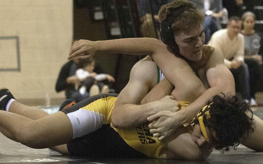 Kubasaki's Oakley Mueller gets the upper hand on Kadena's Fintan Cawley in the 168-pound bout during Wednesday's Okinawa wrestling dual meet. Mueller won by in in 2 minutes, 42 seconds and the Dragons won the meet 42-18.