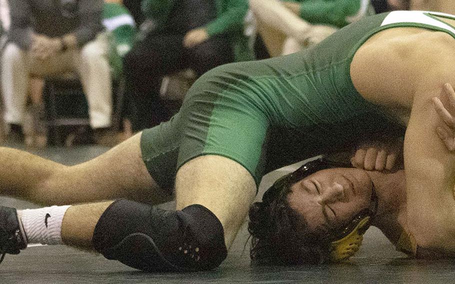 Kubasaki's Luke Moseley gains the edge on Kadena's Logan Howell in the 148-pound bout during Wednesday's Okinawa wrestling dual meet. Moseley won by technical fall 12-0 in 3 minutes and the Dragons won the meet 42-18.