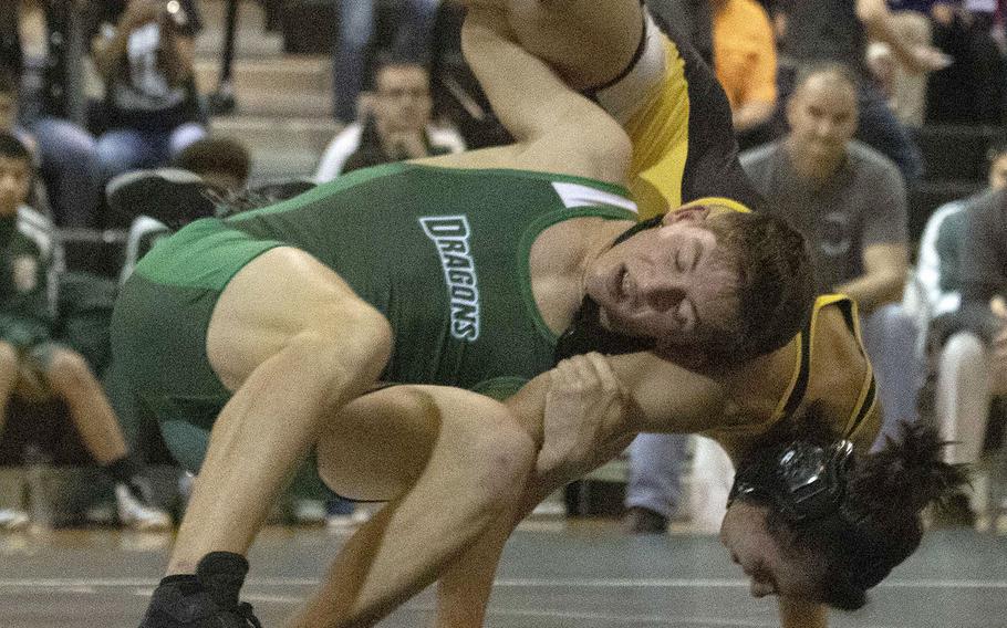 Kubasaki's Colin Lundberg and Kadena's Eric Hansen grapple for the advantage in the 141-pound bout during Wednesday's Okinawa wrestling dual meet. Hansen won a 14-12 decision, but the Dragons won the dual meet 42-18.