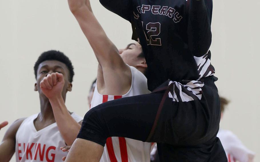 Matthew C. Perry's Jomari Silang goes up to shoot against E.J. King during Saturday's Japan boys basketball game. The Cobras won 60-39.