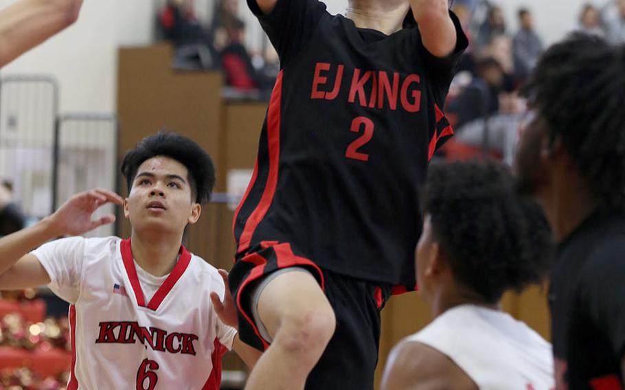 E.J. King's James Meachum skies for a shot against Nile C. Kinnick during Saturday's Japan boys basketball game. The Red Devils won 54-34, handing the Cobras their first loss in nine games this season.