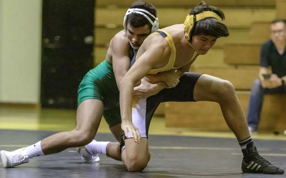Kubasaki's Victor Saavedra takes control of Kadena's Paul Maskery at 135 pounds during Wednesday's Okinawa wrestling dual meet. Saavedra pinned Maskery in 1 minute, 21 seconds, and the Dragons won the meet 50-15.