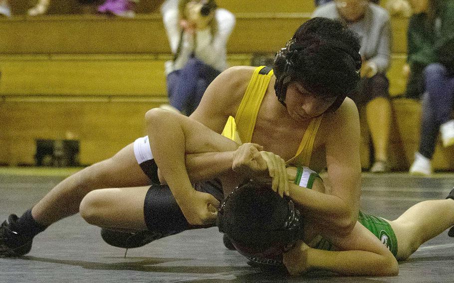 Kadena's Manuel Ramos locks in a half nelson on Kubasaki's Anthony Wallace at 108 pounds during Wednesday's Okinawa wrestling dual meet. Ramos pinned Wallace in 59 seconds, but the Dragons won the meet 50-15.