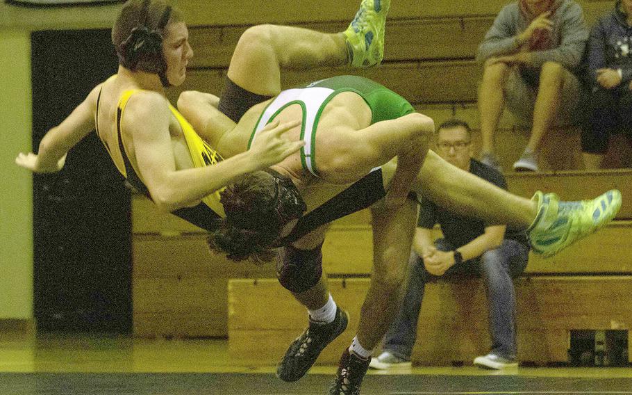 Kadena's Nick Neary gets tossed to the mat by Kubasaki's Luke Moseley in the 158-pound bout during Wednesday's Okinawa wrestling dual meet. Moseley pinned Neary in 33 seconds and the Dragons won the meet 50-15.