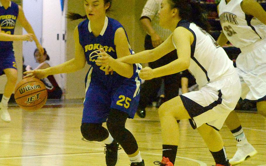 Yokota's Emily Taynton dribbles against Seisen's Lina Saechout during Tuesday's Japan girls basketball game. The Panthers won 32-25.