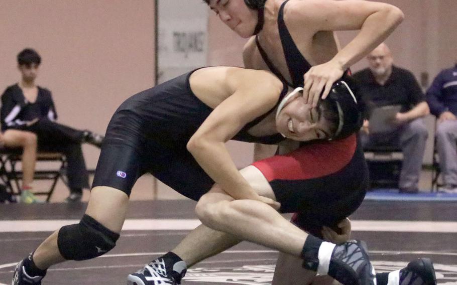 Zama's Kaito Hayashi barrels into Nile C. Kinnick's Jason Charron at 129 pounds during Thursday's Japan wrestling dual meet. Hayashi pinned Charron in 2 minutes, 30 seconds, but the Red Devils won the meet 43-18.