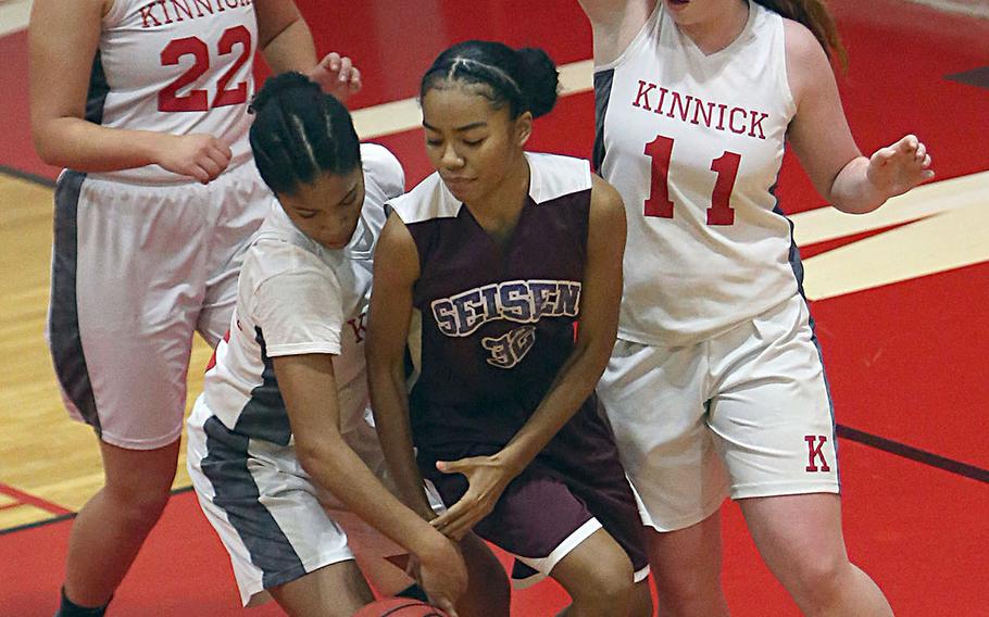 Seise's Yumi Cunhs has the ball stripped by Nile C. Kinnick's Journey Hammond as Red Devils teammates Madelyn Gallo and Cassi Boyer surround the pair during Thursday's Japan girls basketball game. The Phoenix won 34-30 in extra time.