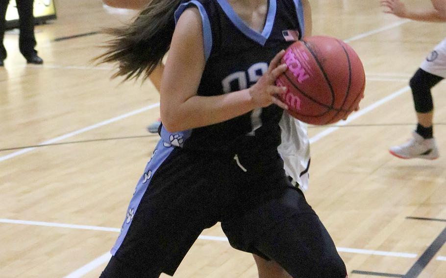 Osan's Maja Inthavixay drives to the basket against Humphreys during Friday's Korea girls basketball game. The Blackhawks won 54-39.