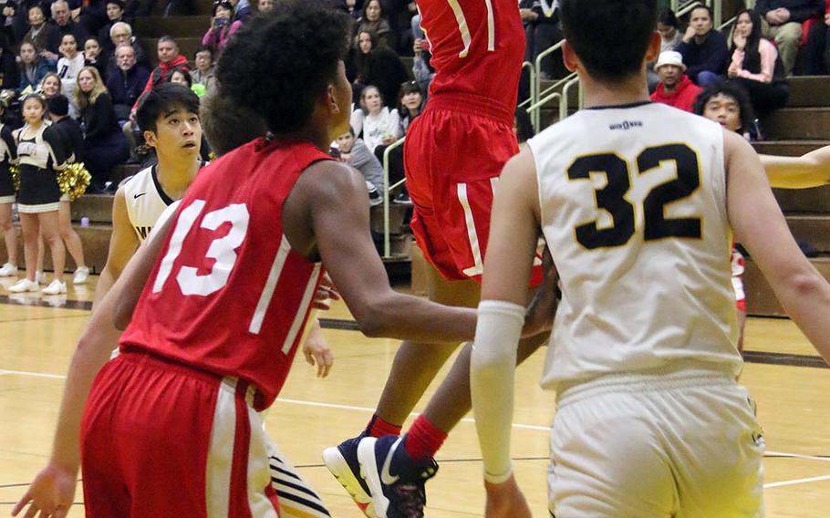 Nile C. Kinnick's Rodrick Bell shoots against American School In Japan during Saturday's rematch of last year's Far East Division I and combined tournament finals. The defending D-I champion Red Devils edged the defending combined champion Mustangs 70-62.