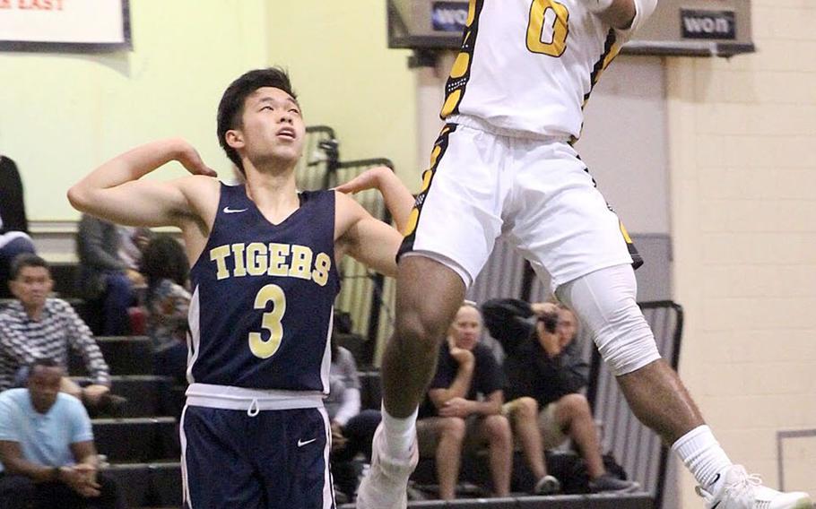 Kadena's Eric McCarter skies for a shot against Taipei American during Sunday's Taipei Basketball Exchange boys game. The Panthers beat the Tigers 70-57, sweeping their two games against Taipei this weekend and improving to 9-0 on the season.