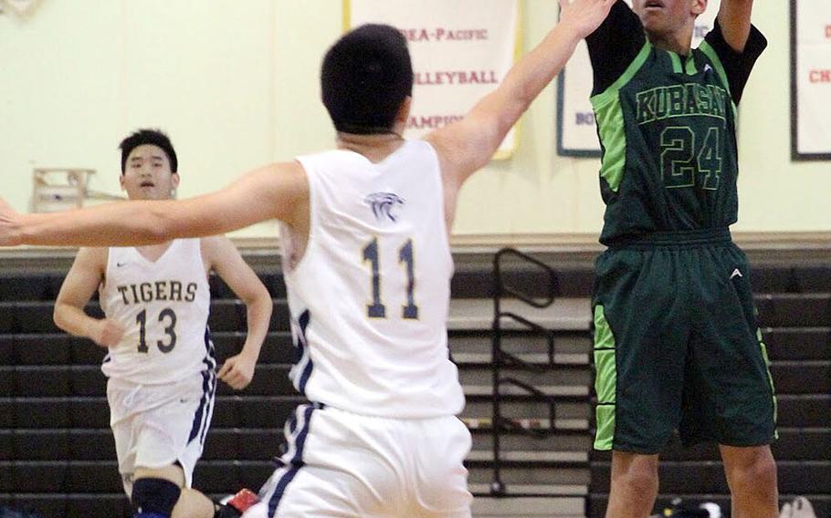 Kubasaki's Tristan Higginson shoots from deep against Taipei American during Sunday's Taipei Basketball Exchange boys game. The Tigers edged the Dragons 65-58.