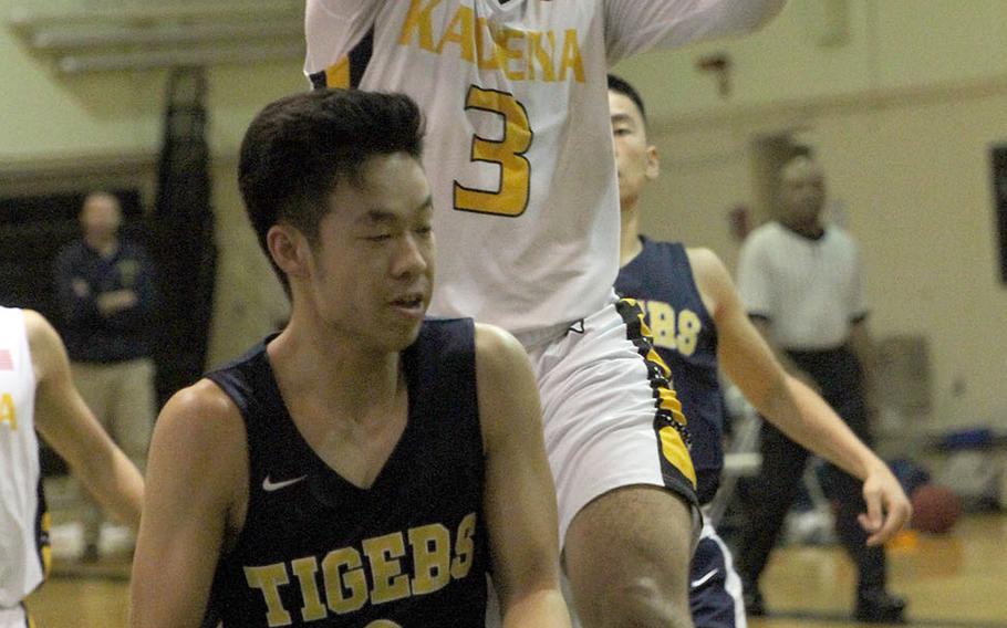 Kadena's Casey Cox drives for a shot against Taipei American during Sunday's Taipei Basketball Exchange boys game. The Panthers won 70-57, sweeping their two games this weekend against the Tigers.